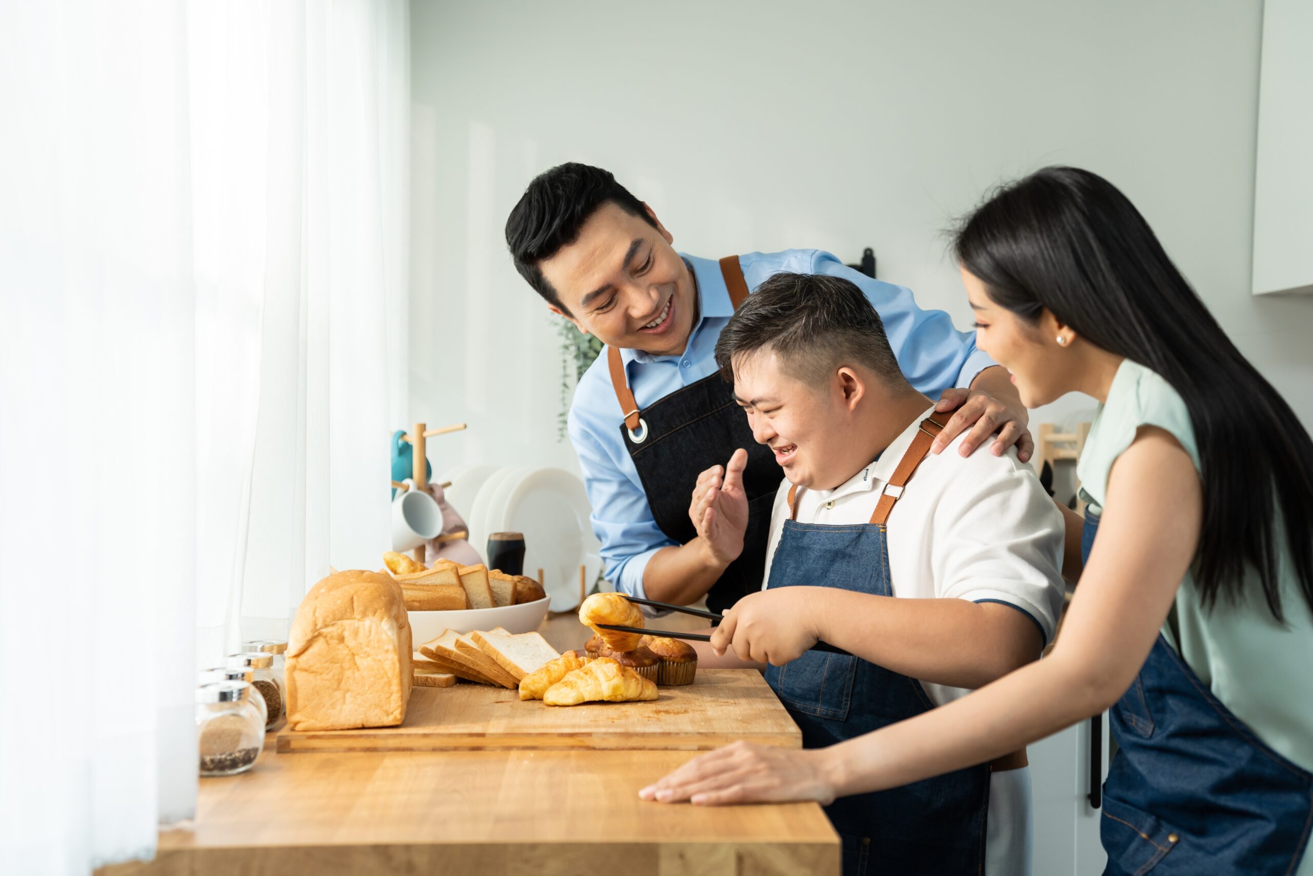 Asian,Happy,Family,,Mature,Parents,Baking,Bakery,With,Son,In