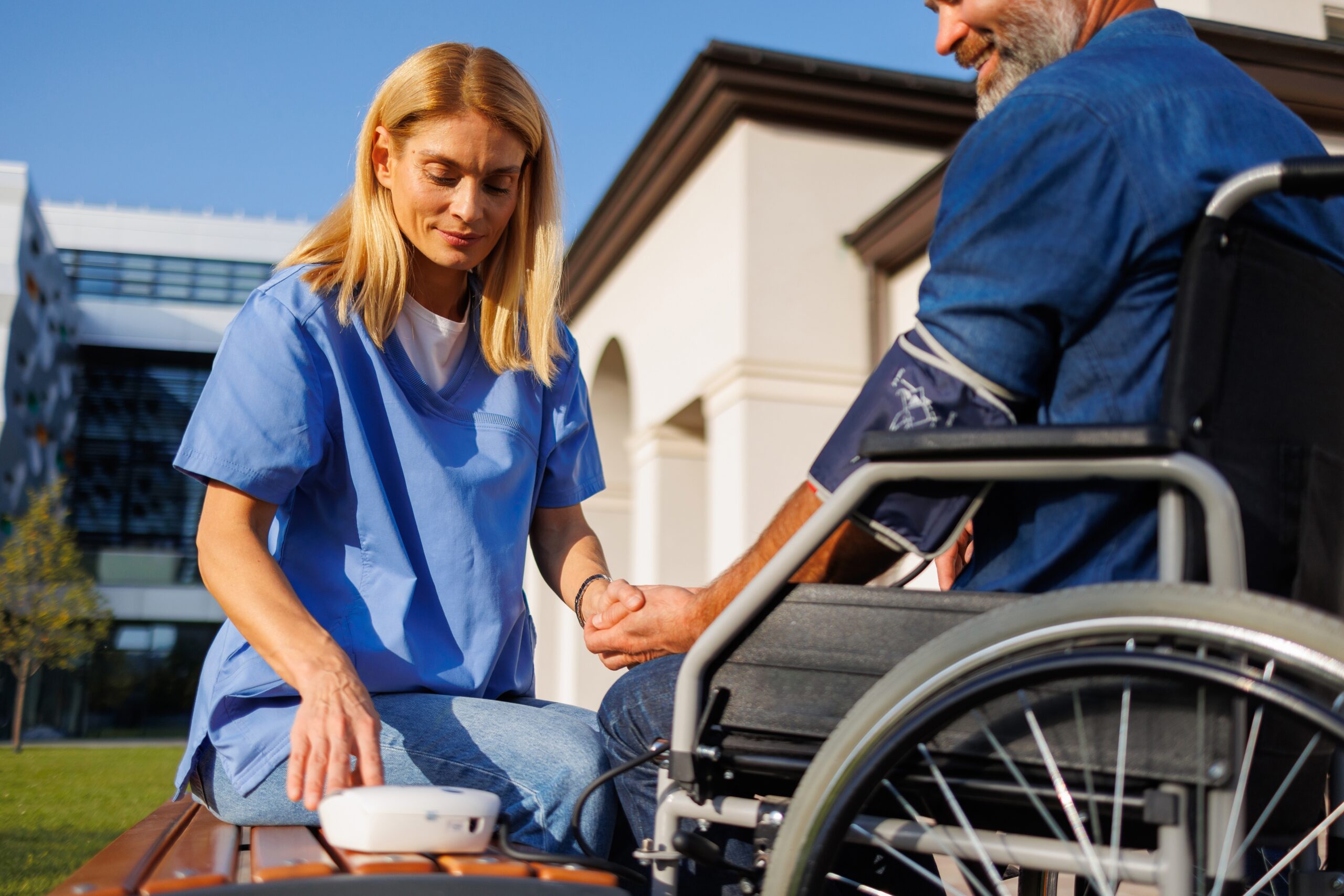 Outdoor,Healthcare:,Nurse,Checks,Blood,Pressure,Of,Wheelchair-bound,Man